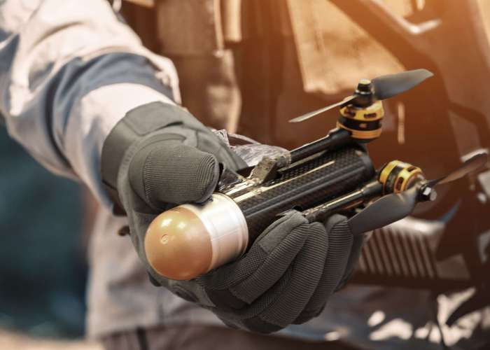 The soldier holds in his hand a training grenade while passing military exercises in the army.